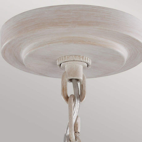 Close-up of the charming Hartsville 3 Light Chandelier in Chalk Washed/Beachwood, resembling a rustic chandelier with a round, wooden-like plate and chain link. Perfect for coastal casual spaces, it features an aged appearance with a light, weathered finish against a plain background.