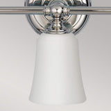 Introducing the Huguenot Lake 3 Light Wall Light in Polished Chrome, featuring a modern design with a sleek chrome base and frosted white glass shades. The fixtures hang downward from their metallic supports, creating a minimalist aesthetic that perfectly complements neutral backdrops and embodies the essence of contemporary wall lighting.