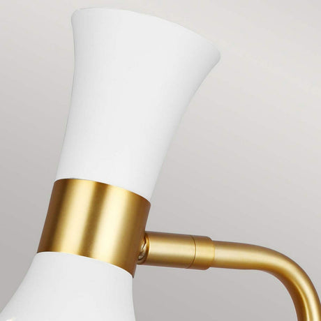 Close-up of the Joan 1 Light Table Lamp, featuring a matte white, flared shade with burnished brass accents on the neck and arm, set against a plain background.