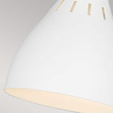 Close-up of the Joan 1 Light Table Lamp in matte white with burnished brass accents, featuring vertical slits near its top edge. The soft, diffused glow resembles that of a traditional table lamp, beautifully illuminating the interior against a neutral background.