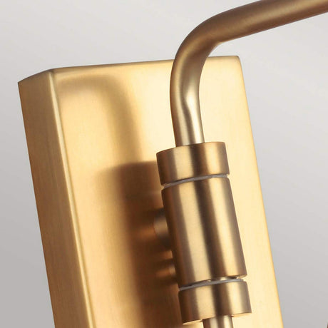 Close-up of the Joan 1 Light Wall Light in burnished brass, showcasing a modern aesthetic with its sleek, brushed finish. The fixture features a rectangular backplate and a curved arm, embodying minimalist design against a light gray background.