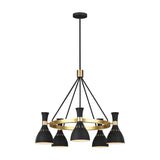 The Joan 5 Light Chandelier - Midnight Black/Burnished Brass features a sleek modern design with five lampshades in Midnight Black complemented by Burnished Brass accents, all elegantly suspended from a central rod. Its circular base seamlessly connects the shades, offering an elegant and contemporary look.