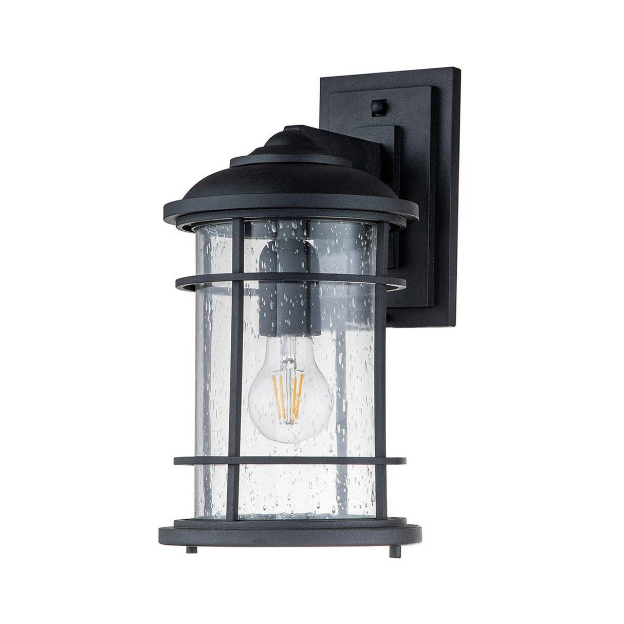 The Lighthouse 1 Light Outdoor Medium Wall Lantern in Textured Black showcases a speckled, clear cylindrical glass casing with a visible LED bulb. Its nautical design is beautifully complemented by a sleek rectangular black wall plate, enhancing the charm of any exterior space.