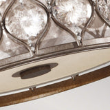 An intricate close-up highlights the Lucia 2 Light Flush chandelier, boasting an ornate circular frame adorned with Bauhinia crystals. The patterned grid design of the crystals creates dazzling light reflections, while a soft neutral backdrop accentuates its sophisticated burnished silver finish.
