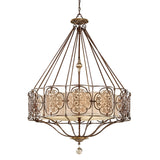 The Marcella 4 Light Chandelier in Bronze features intricate metalwork and a circular beige shade. It boasts ornate patterns and a central decorative element, epitomizing luxury lighting while hanging gracefully from a chain.