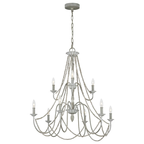 The Maryville 9 Light Chandelier - Washed Grey embodies French Country elegance with its two-tiered, nine candle-style lights. Its design includes graceful cascading chains and an intricately detailed metal frame, adding a touch of rustic charm to any room while being stylishly suspended by a chain from a circular ceiling mount.