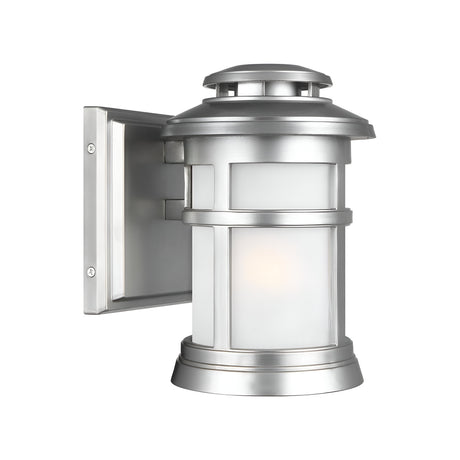 Elevate your outdoor space with the Newport 1 Light Outdoor Small Wall Lantern in a brushed steel finish. Featuring a sleek cylindrical design and frosted glass panels, it is elegantly mounted on a stylish square backplate for a touch of coastal sophistication.