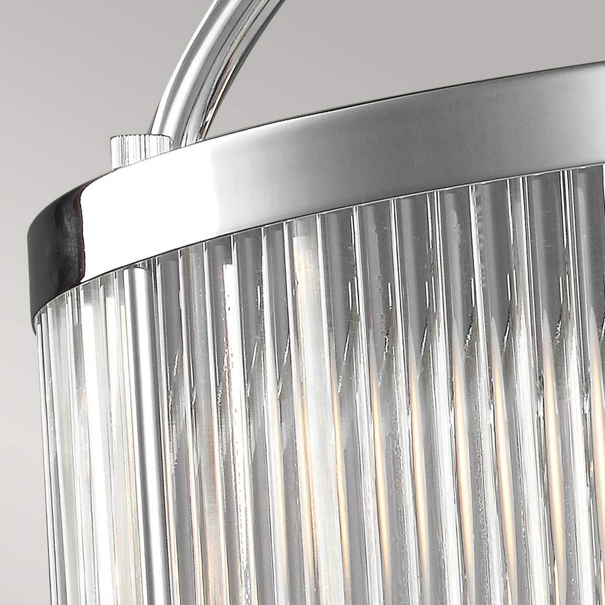 Close-up of the Paulson 6 Light Pendant - Chrome, featuring vertical glass tube shades. The light filters through the clear glass, offering a modern and sophisticated look against a neutral background.