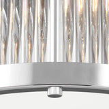 The Paulson 2 Light Flush - Chrome features a modern design with vertical, cylindrical glass rods and a sleek chrome-finished base. When illuminated, the rods cast a warm light downward, and at the center of this flush mount design is a small adjustment knob.