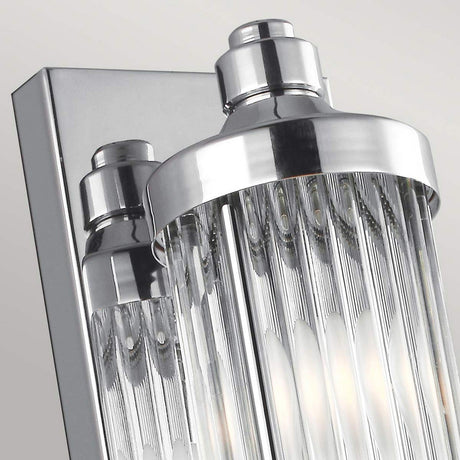 Close-up of the Paulson 4 Light Bar Light - Chrome, featuring modern chrome detailing and vertical glass tube shades. The fixture reflects light beautifully, creating a sleek and elegant look against a light gray background.