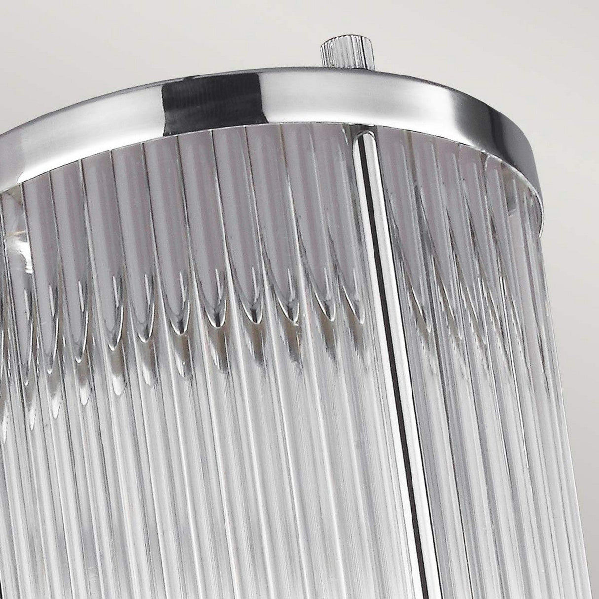 Close-up of the Paulson 1 Light Wall Light in chrome, featuring a modern glass tube shade with a cylindrical shape. The polished chrome design beautifully reflects light, adding a sleek, contemporary touch perfect for use as an IP44 bathroom light.