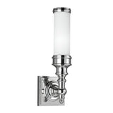 The Payne-2 1 Light Wall Light in polished chrome features a cylindrical opal etched glass shade and an ornate base connected to a square backplate, subtly evoking Tudor style.