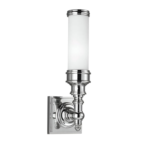The Payne-2 1 Light Wall Light in polished chrome features a cylindrical opal etched glass shade and an ornate base connected to a square backplate, subtly evoking Tudor style.