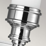 A close-up of the Payne-2 1 Light Wall Light in polished chrome showcases its metallic, cylindrical shape with a smooth, reflective surface. The opal etched glass elegantly enhances its design against a plain, light gray background.