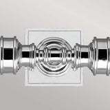 Close-up of the Payne-1 polished chrome finish wall light, featuring an ornate, symmetrical design mounted on a square backplate against a light background.
