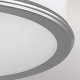 A close-up view of the Payne 2 Light Flush - Polished Chrome fixture highlights its sleek chrome frame and frosted white diffuser. The flush design harmonizes beautifully with the simple light grey background.