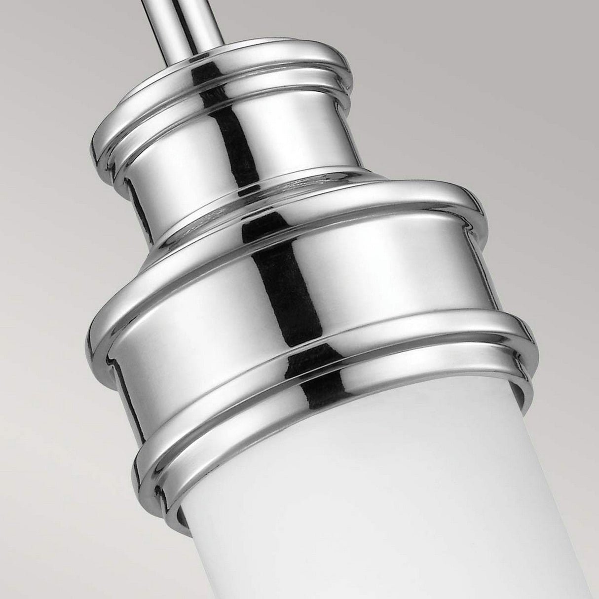 The Payne 1 Light Mini Pendant in polished chrome features a sleek, cylindrical design. The metallic finish beautifully contrasts with an opal etched glass shade, creating a modern and elegant appearance.