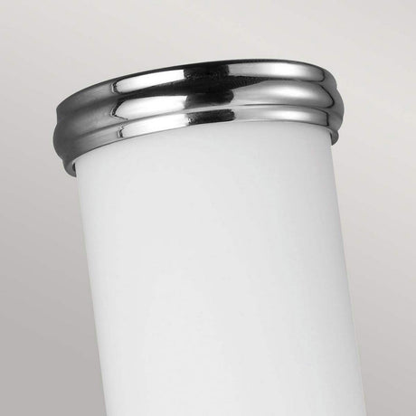 A close-up of the Payne-1 1 Light Wall Light - Polished Chrome against a light gray background. The sleek and modern design, resembling white opal etched glass, is highlighted by its shiny silver rim and smooth surface.