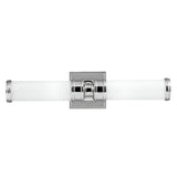 The Payne-2 2 Light Wall Light - Polished Chrome is a stylish wall sconce with two lights, showcasing a polished chrome finish and cylindrical frosted glass shades, all mounted on a square base. Its modern, minimalistic design beautifully enhances contemporary interiors.