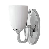 The Perry 1 Light Wall Light - Polished Chrome features an upward-facing frosted opal glass shade and a polished chrome base, offering a modern and sleek design ideal for indoor wall-mounted bathroom lighting.