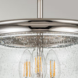 The Pickering Lane 3 Light Semi Flush in polished nickel features a metallic pendant light fixture with a clear glass shade. Inside, elongated filament-style bulbs add warmth and character. The bubbled texture on the glass enhances its sleek, modern design, perfectly blending farmhouse lighting charm with contemporary elegance against a soft, neutral backdrop.