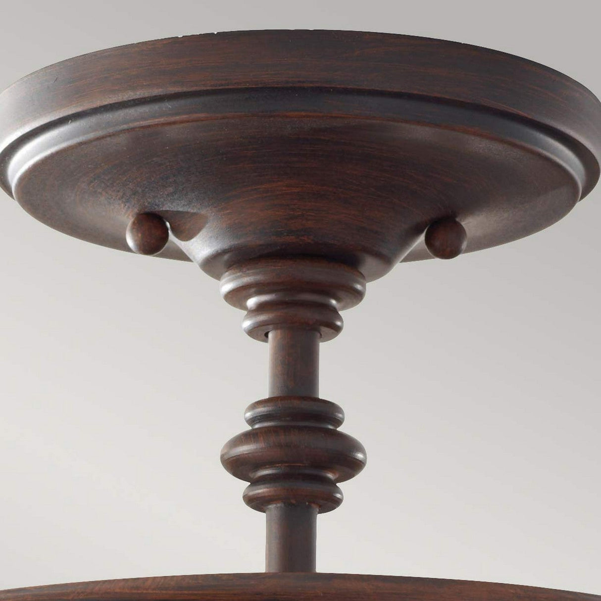 Capture the intricate design of the Pickering Lane 3 Light Semi Flush in bronze with its detailed turned column features. The bronze finish beautifully complements a rustic farmhouse aesthetic, providing a vintage look against a simple gray backdrop.