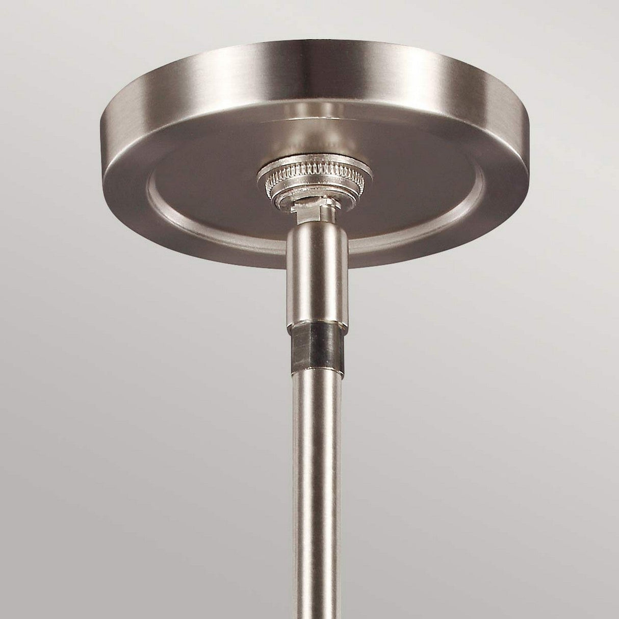Close-up of the Prospect Park 3 Light Island Chandelier, showcasing a modern metallic ceiling mount with a sleek circular ceiling plate and cylindrical rod. Its satin nickel finish provides a contemporary, polished look that perfectly complements the opal etched glass or chandelier designs.