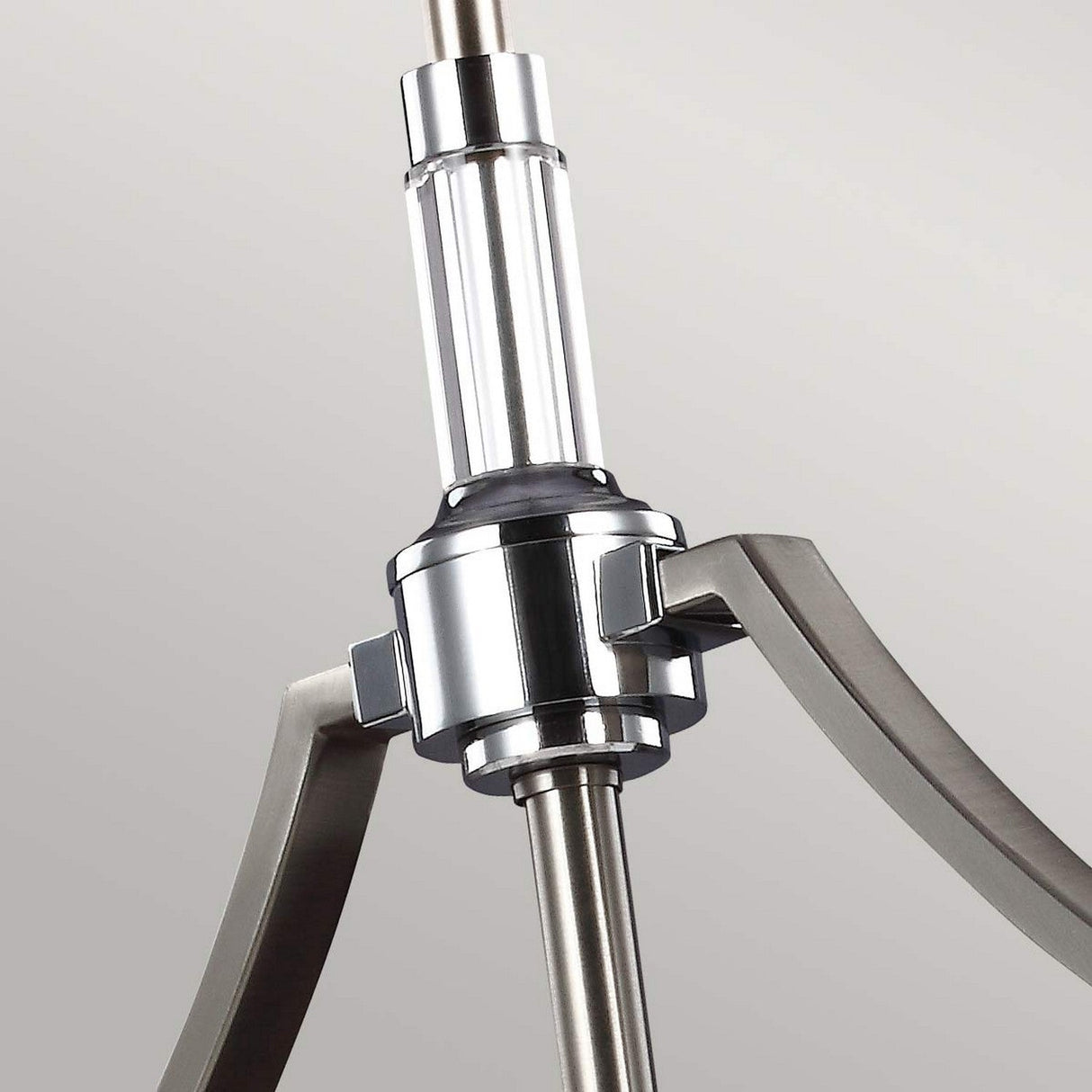 A close-up view shows the Prospect Park 3 Light Island Chandelier, featuring sleek, curved arms and an opal etched glass finish on its polished cylindrical central rod, set against a light gray background.