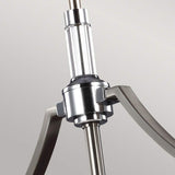 A close-up view shows the Prospect Park 3 Light Island Chandelier, featuring sleek, curved arms and an opal etched glass finish on its polished cylindrical central rod, set against a light gray background.