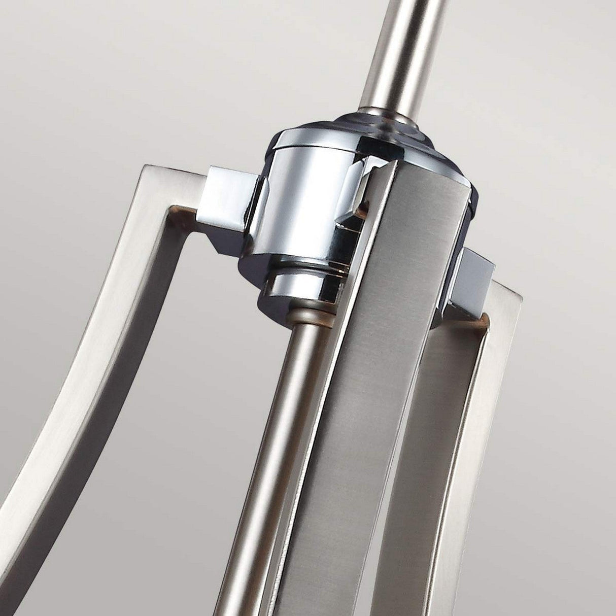 Close-up of the Prospect Park 4 Light Chandelier, showcasing its sleek, geometric lines with a central cylindrical fixture adorned with opal etched glass shades. The neutral background amplifies the Satin Nickel and Chrome finish, elegantly highlighting its modern design.