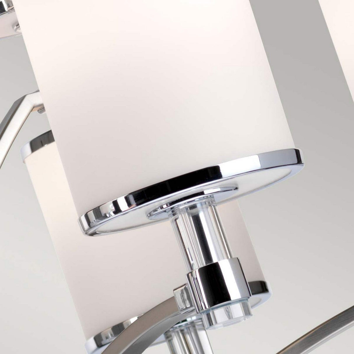 Close-up of the Prospect Park 9 Light Chandelier showcasing opal etched glass shades and chrome accents. The image emphasizes its sleek design, satin nickel finish, and intricate detailing, embodying a contemporary style.