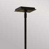 The Remy 1 Light Pendant Light showcases a minimalist design, featuring a sleek and slender stand complemented by a square, flat top in an elegant Heritage Bronze finish against a simple gray backdrop. The style is both contemporary and timeless.