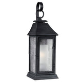 Introducing the Shepherd 2 Light Outdoor Medium Wall Lantern in Dark Weathered Zinc: a black metal fixture that showcases a classic Parisian design. It features clear glass panels and a loop handle on top, while its subtly tapered roof adds an elegant flair. The weather-resistant construction guarantees enduring beauty.
