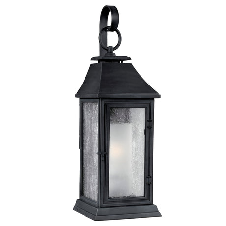 Introducing the Shepherd 2 Light Outdoor Medium Wall Lantern in Dark Weathered Zinc: a black metal fixture that showcases a classic Parisian design. It features clear glass panels and a loop handle on top, while its subtly tapered roof adds an elegant flair. The weather-resistant construction guarantees enduring beauty.