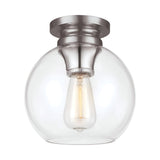 The Tabby 1 Light Flush - Polished Nickel is a ceiling-mounted fixture that showcases a round, clear glass globe with an exposed filament bulb. The base features a polished nickel finish with a brushed texture. This piece combines contemporary lighting design with simplicity, offering a warm and inviting glow.