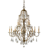 The Valentina 12 Light Chandelier - Oxidized Bronze showcases luxurious, antique-style craftsmanship with intricate oxidized bronze metalwork. Its design features multiple tiers adorned with crystal bobeches and twelve candle-shaped light bulbs, offering an elegant and classic ambiance.