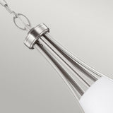 Close-up of a contemporary pendant light fixture finished in satin nickel. It showcases a tapered, elongated design with opal etched glass shades at the base, suspended by a chain against a neutral backdrop, evoking the style of the Vintner 5 Light Chandelier - Satin Nickel.