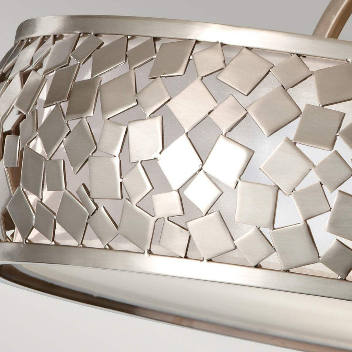 Close-up of the Zara 3 Light Semi Flush in brushed steel, showcasing a mosaic pattern of interlocking, irregular square pieces. The surface glistens as it reflects light, and the contemporary design offers an intricate texture.