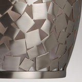 A close-up of the Zara 1 Light Wall Light in brushed steel showcases abstract, star-shaped cutouts, with its reflective material embodying contemporary design. This creates a pattern of varying shapes and sizes set against a neutral background.