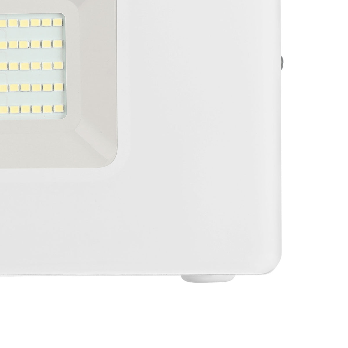 Close-up of the Fesvine LED flood light's corner, showing the white aluminium body, recessed LED panel behind clear glass, and mounting bracket on a plain background.