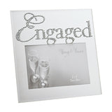 Square silver mirror glass photo frame with "Engaged" spelt in crystal script across the top, holding a 6 x 4in champagne glasses photo, shown on a white background.