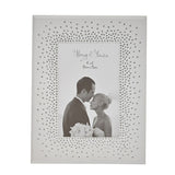 Rectangular mirrored photo frame in silver with a dense starburst of clear crystals around the opening, holding a 4x6 wedding couple photo on a white background.