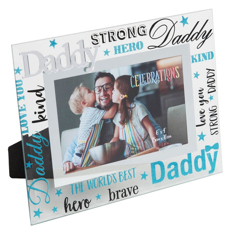 Glass 6x4in landscape photo frame with raised silver Daddy text and blue glitter lettering reading strong, hero, kind, brave and love you, shown with a family photo.