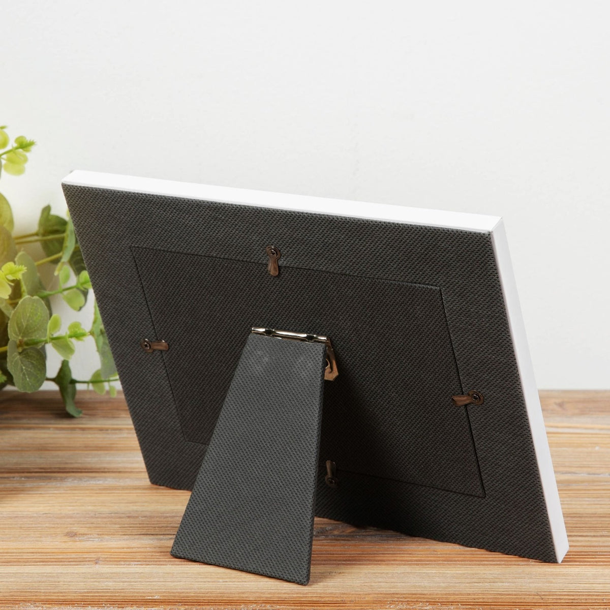 Rear view of the On Your Special Day grey photo frame for a 6 x 4in photo, showing the fabric-textured back, foldout stand, and hanging hooks.