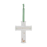 White wooden Confirmation hanging cross plaque with gold lettering, a dove, leaf sprigs, stars and a church illustration, hung on a sage green ribbon against a plain white background.
