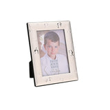 Silver metal photo frame with raised chalice and ring details on a broad sloped border, easel back, holding a 5 x 3.5in portrait photo on a white background.