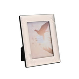 Silverplated rectangular easel photo frame with polished silver border, fine-outline dove detail in the lower left corner, holding a 5 x 3.5in portrait photo, shown on a plain white background.