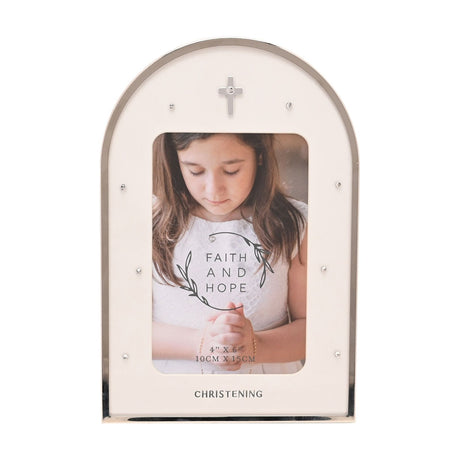 Arched freestanding photo frame with white face and silver rim, a small cross and clear studs at the top, "CHRISTENING" printed below a 4x6in photo opening, on a plain white background.