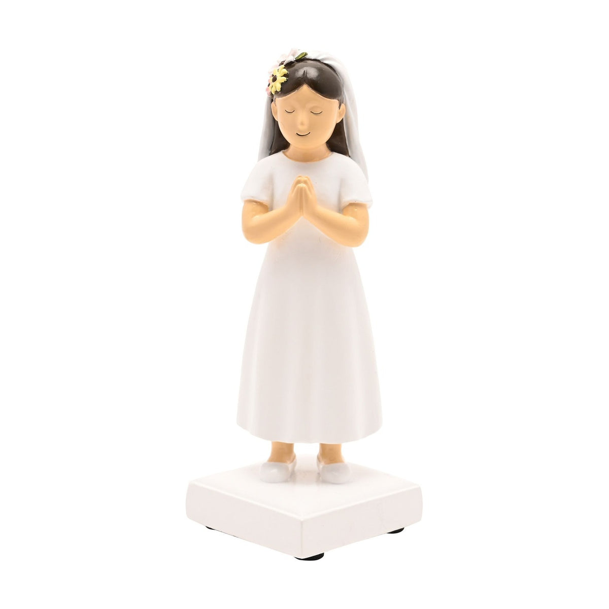 Communion Girl Figurine in resin, dark brown hair, praying with eyes closed, white dress and veil with floral crown, on a white square base against a plain background.