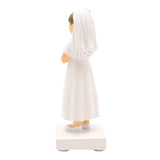 Rear view of a resin Communion girl figurine with light brown hair, wearing a long white dress with puffed sleeves and a flowing veil, hands clasped, on a white base.